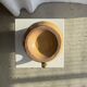 Large antique handmade ochre yellow jug with a pink flower pattern.