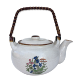 Vintage teapot in wicker handle sandstone