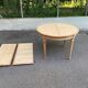 Extendable round table in renovated Louis XVI style, made of light wood, with 2 extensions.