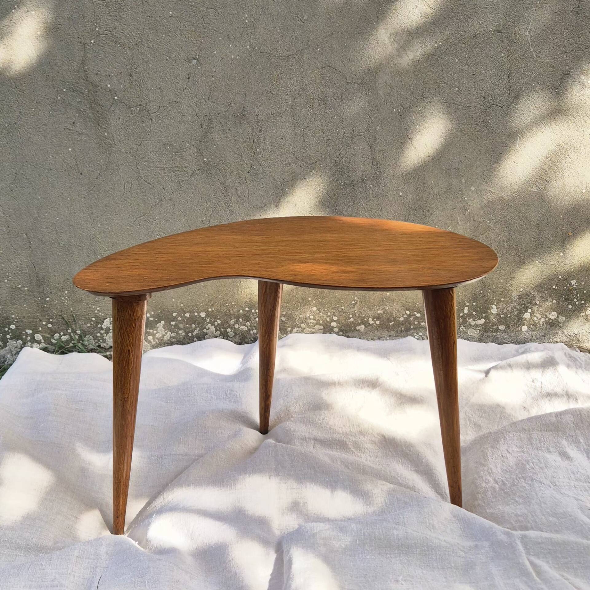 Vintage Scandinavian bean side table with wooden tapered legs.