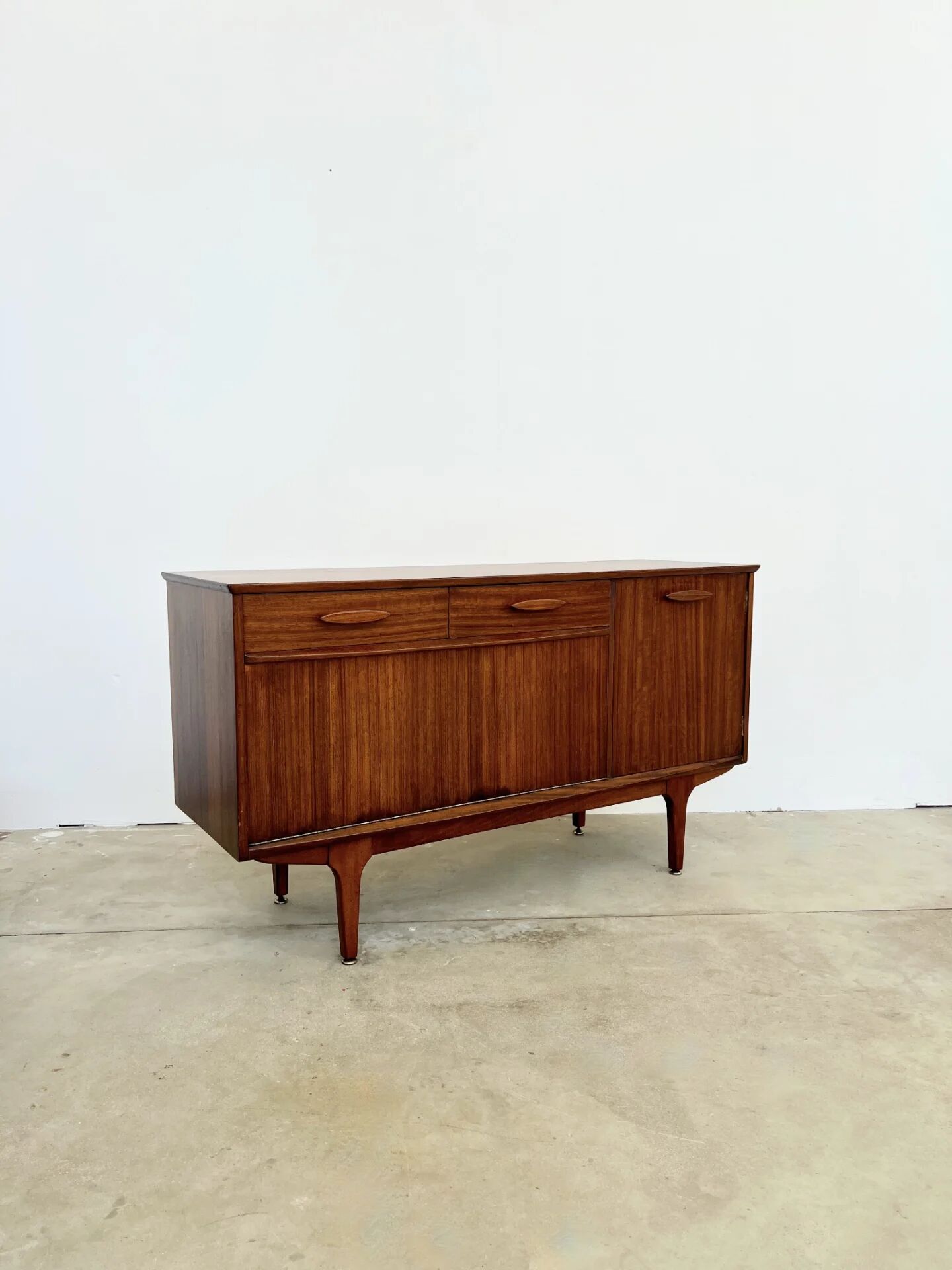 Teak Jentique sideboard — 1 door, 2 drawers & drop-down bar, England 1950s-60s