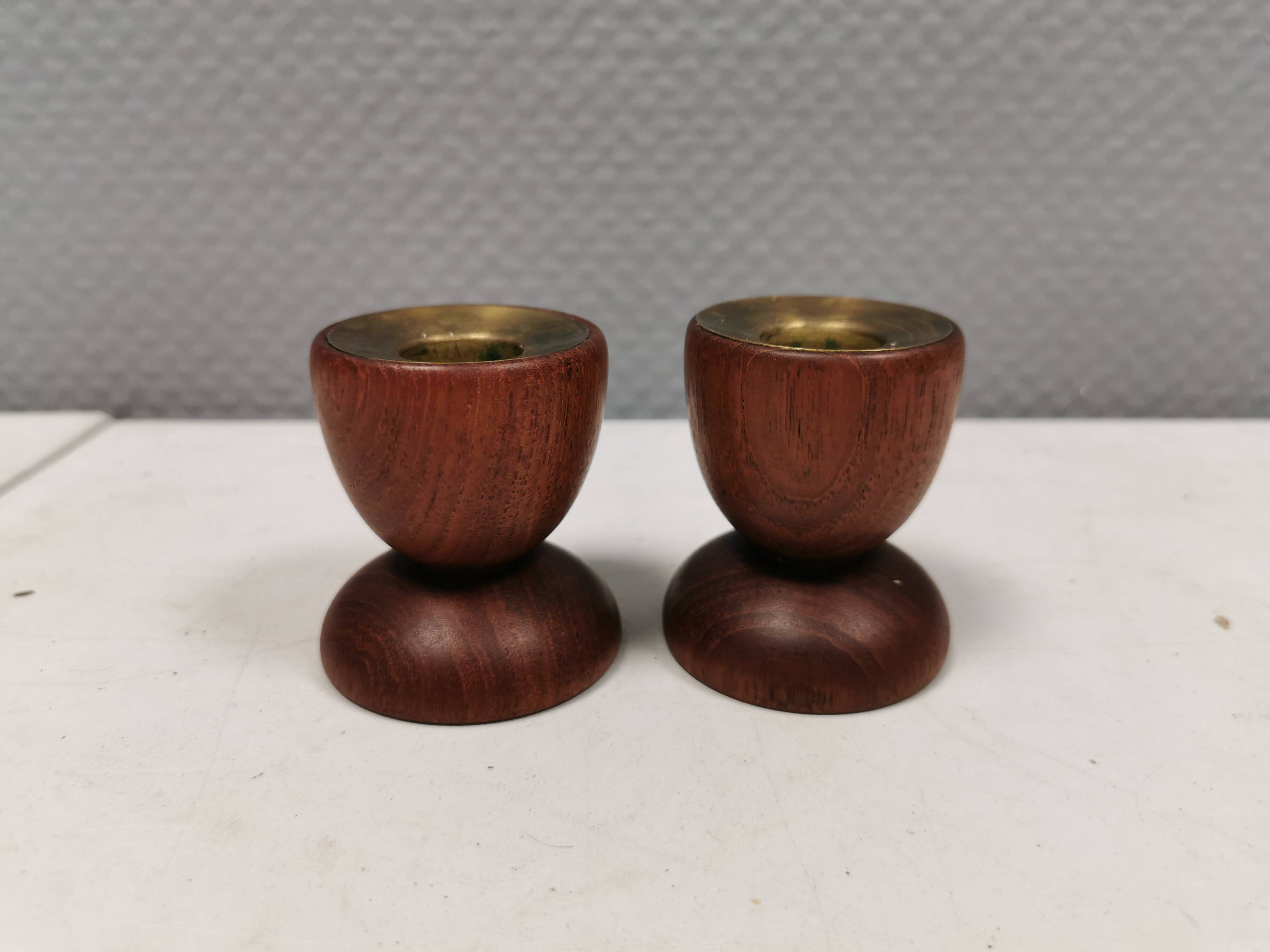 Two beautiful teak candle holders with brass inserts.
