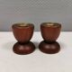 Two beautiful teak candle holders with brass inserts.