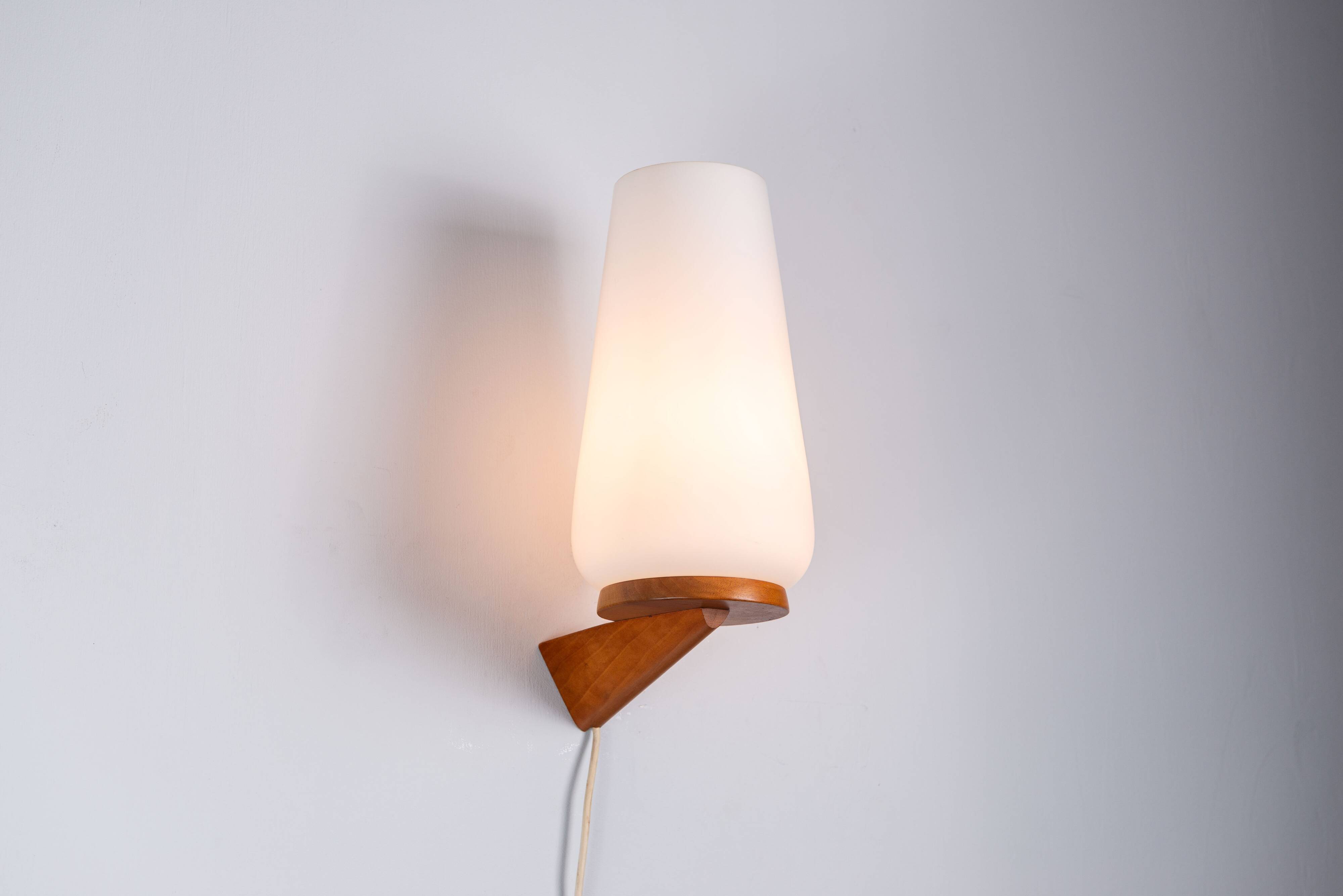 Wall lamp with opal glass shade on wooden base by Philips