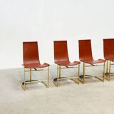 Set of four leather and brass Italian dining chairs