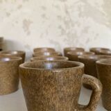 Set of stoneware coffee cups with saucers