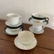 5 coffee cups in white, gold and black
