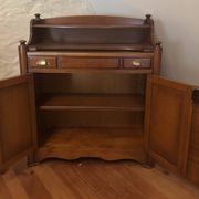 Vintage drop-leaf secretary with a green leather top and inlays.
