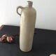 Old stoneware bottle with ear, loop