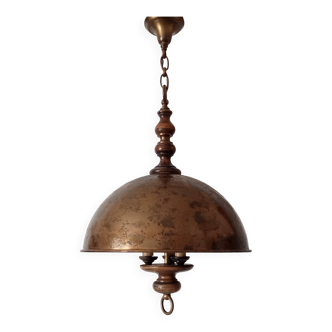 Rustic old wooden and brass suspension.