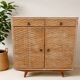 Vintage woven rattan furniture with tapered legs.