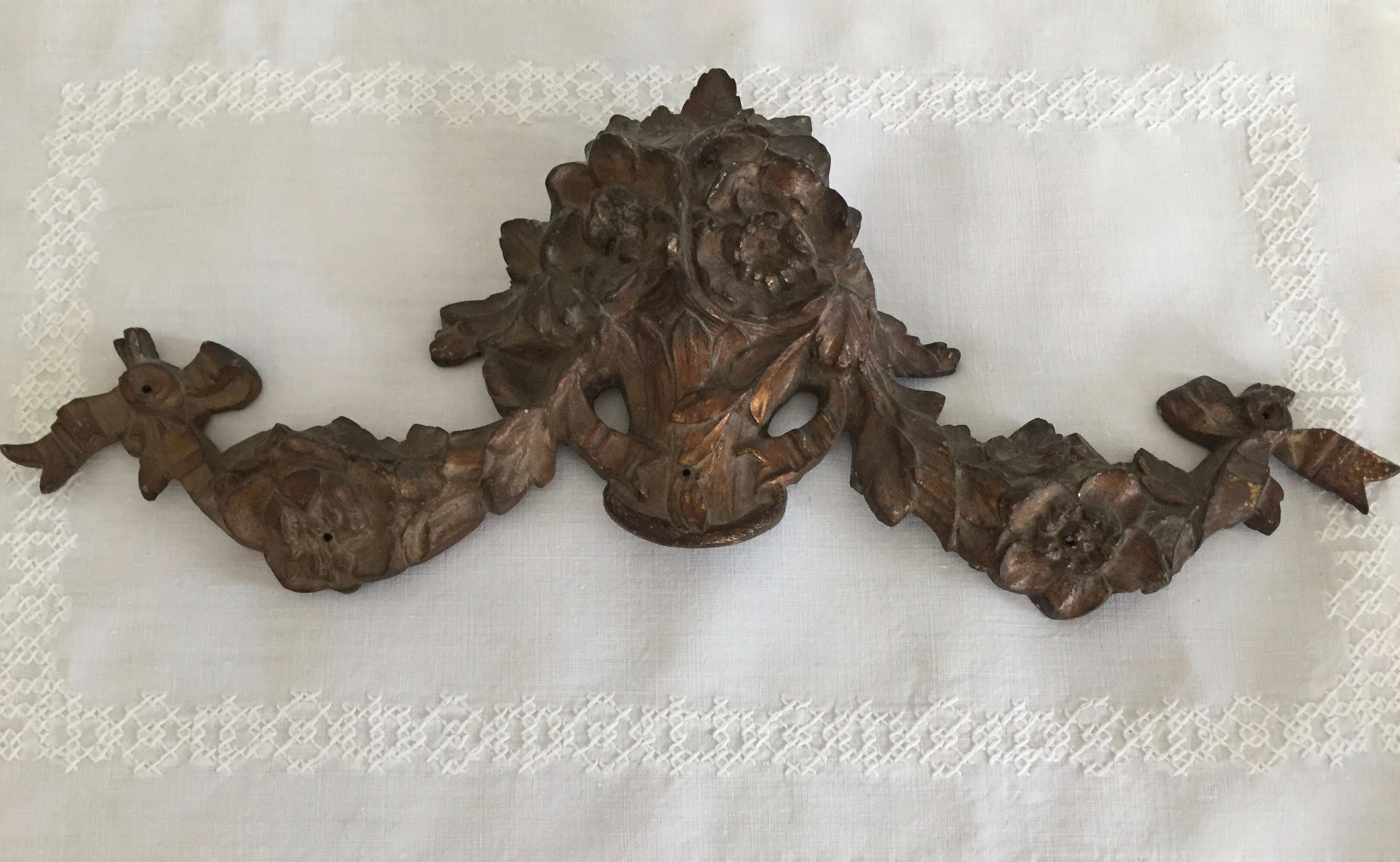 Old brass pediment, floral motifs and ribbon