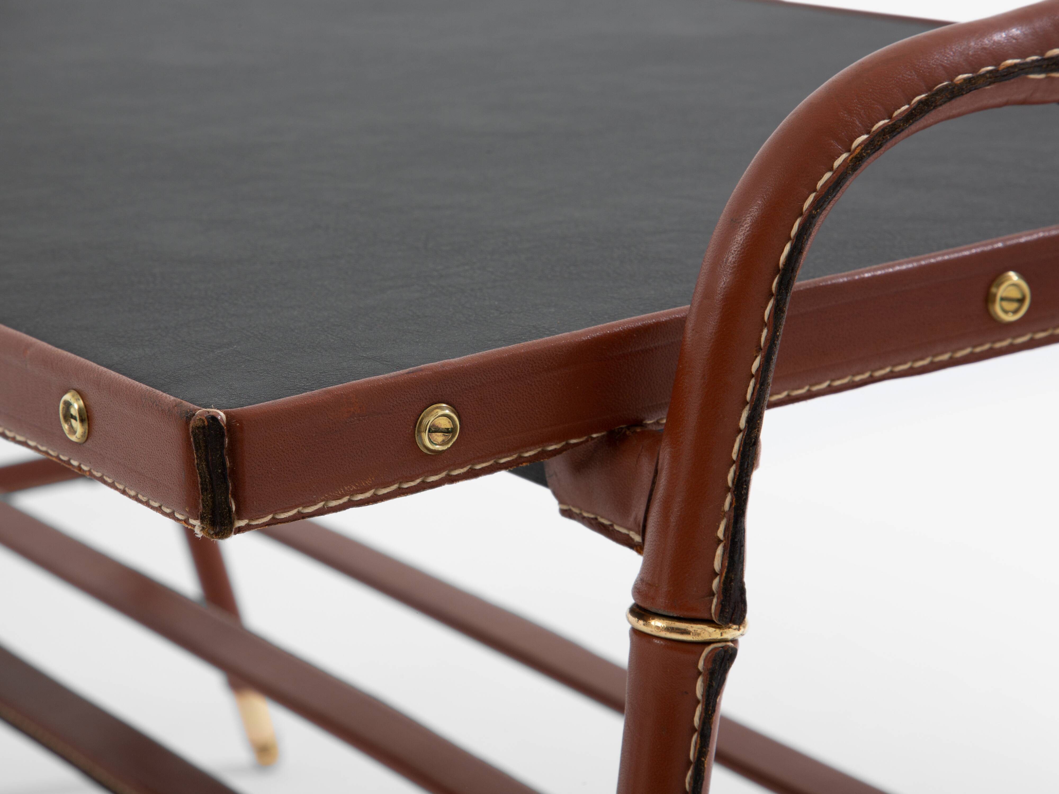 Jacques Adnet coffee table in red saddle-stitched leather and brass, 1950s