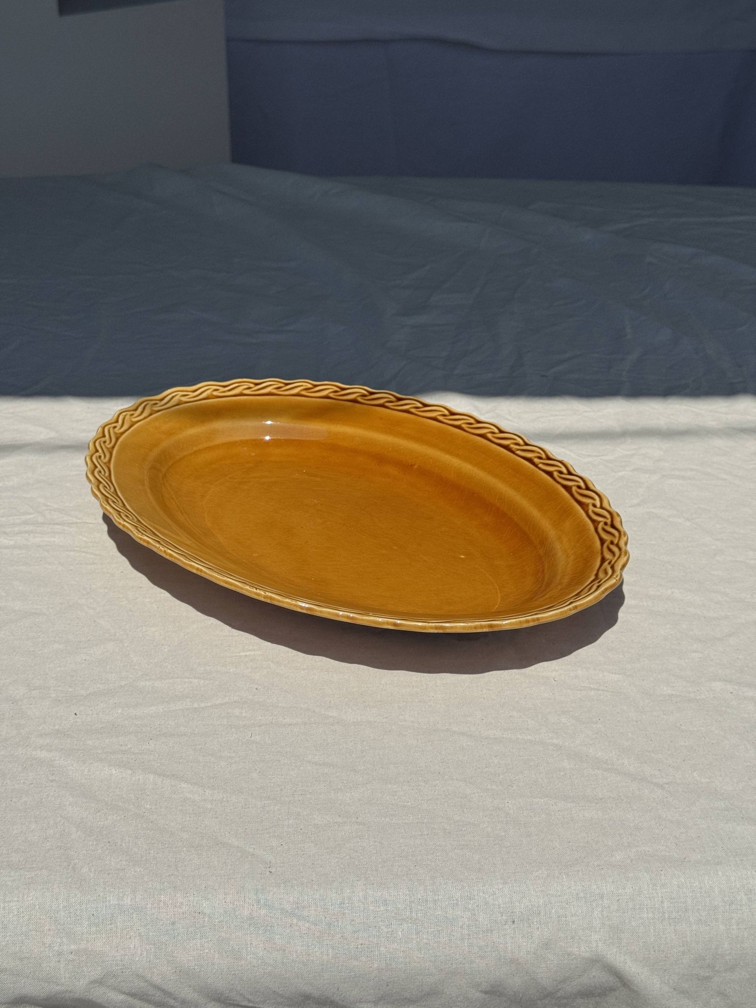 Antique oval dish, yellow-orange, frieze border L:24