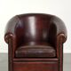Vintage sheepskin club armchair with decorative nails and black piping