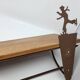 Wall shelf in wood and metal with a decoration of ice skaters.