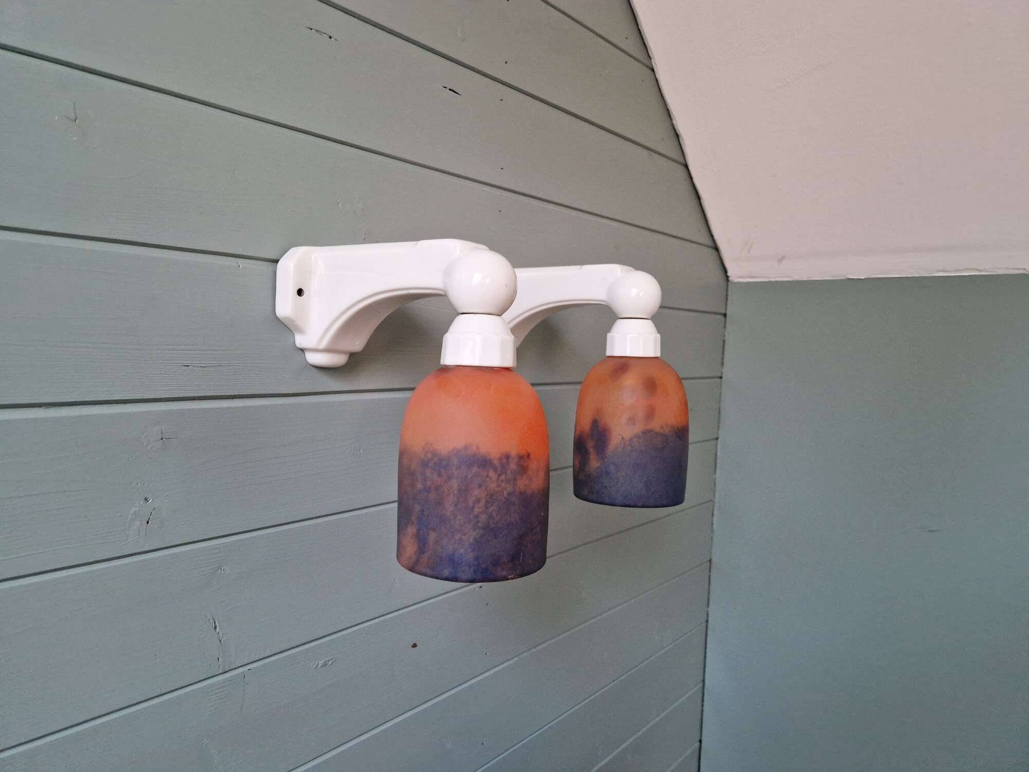 Pair of Art Deco wall sconces in multicoloured porcelain and frosted glass.