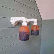 Pair of Art Deco wall sconces in multicoloured porcelain and frosted glass.