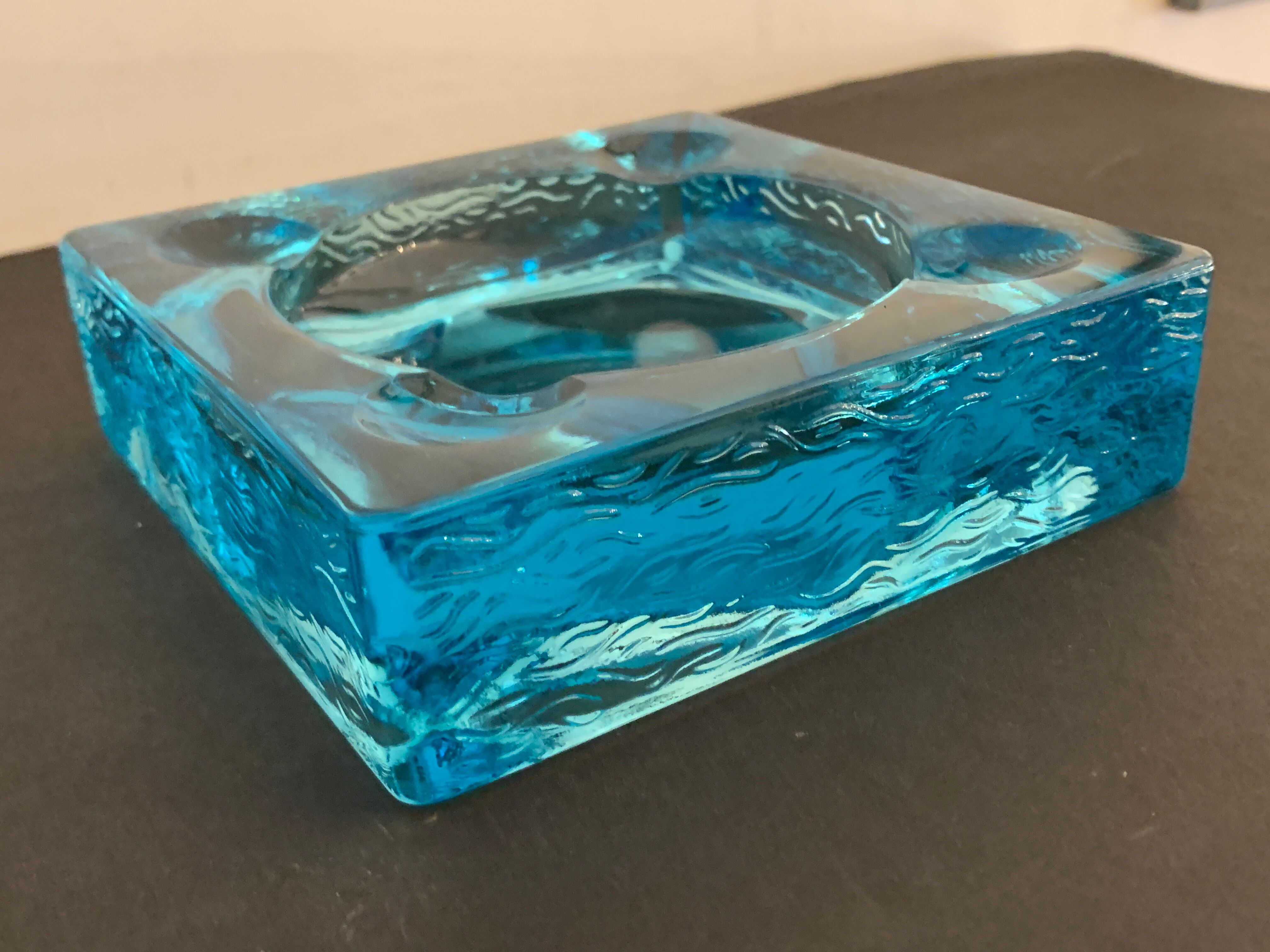 Ashtray paved in blue glass