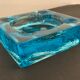 Ashtray paved in blue glass