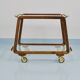 May include: A mid-century modern bar cart with a dark wood frame and two c