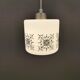 Scandinavian hanging lamp in white glass with inlayed black motifs.