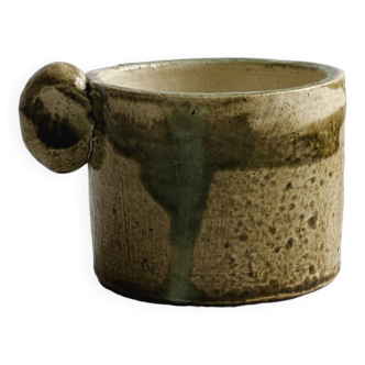Ceramic mug, green and beige tones.