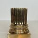 A pair of brass bookends representing columns.