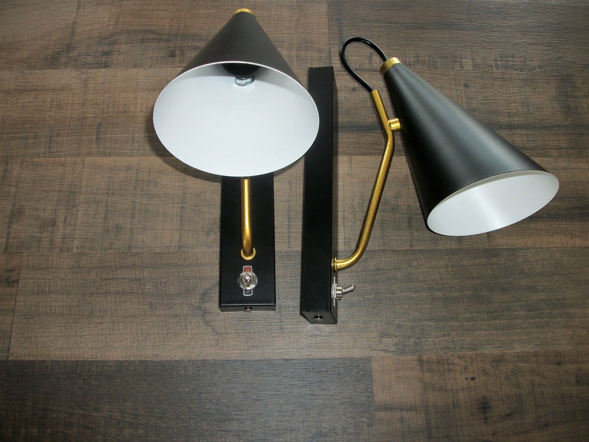 Pair of modernist sconces in black and gold metal