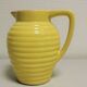 Yellow pitcher in slurry, faience onnaing frères