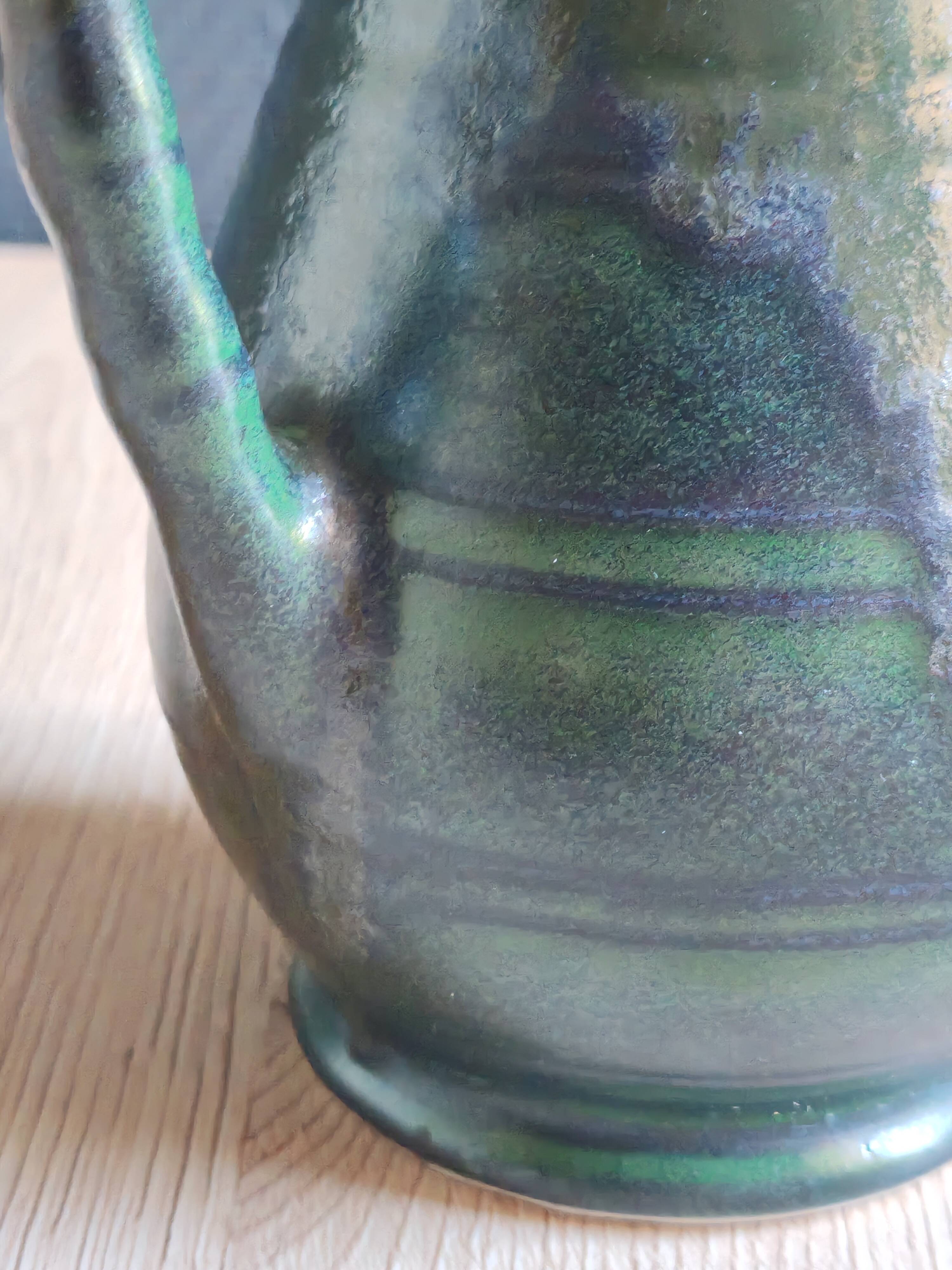 Vintage ceramic pitcher vase in glazed green and blue.