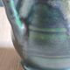 Vintage ceramic pitcher vase in glazed green and blue.