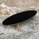 Oval coffee table with a black tray and oak-turned feet