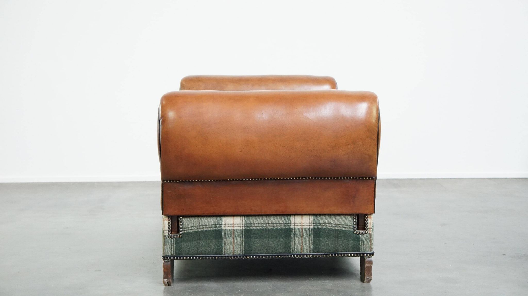 Antique daybed reupholstered with sheepskin and Scottish tartan wool