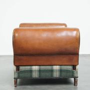 Antique daybed reupholstered with sheepskin and Scottish tartan wool