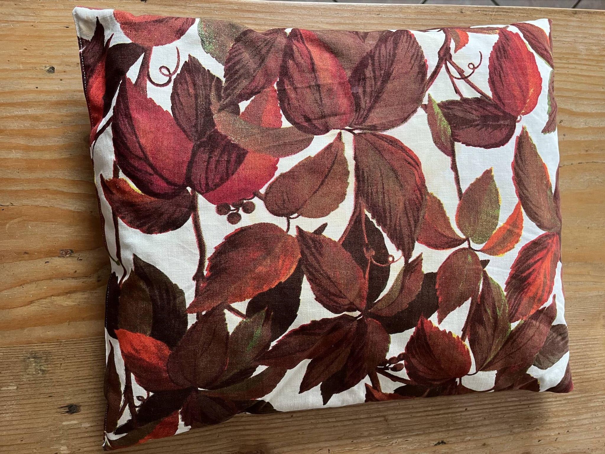 Vintage cushion with virgin vine leaf pattern.