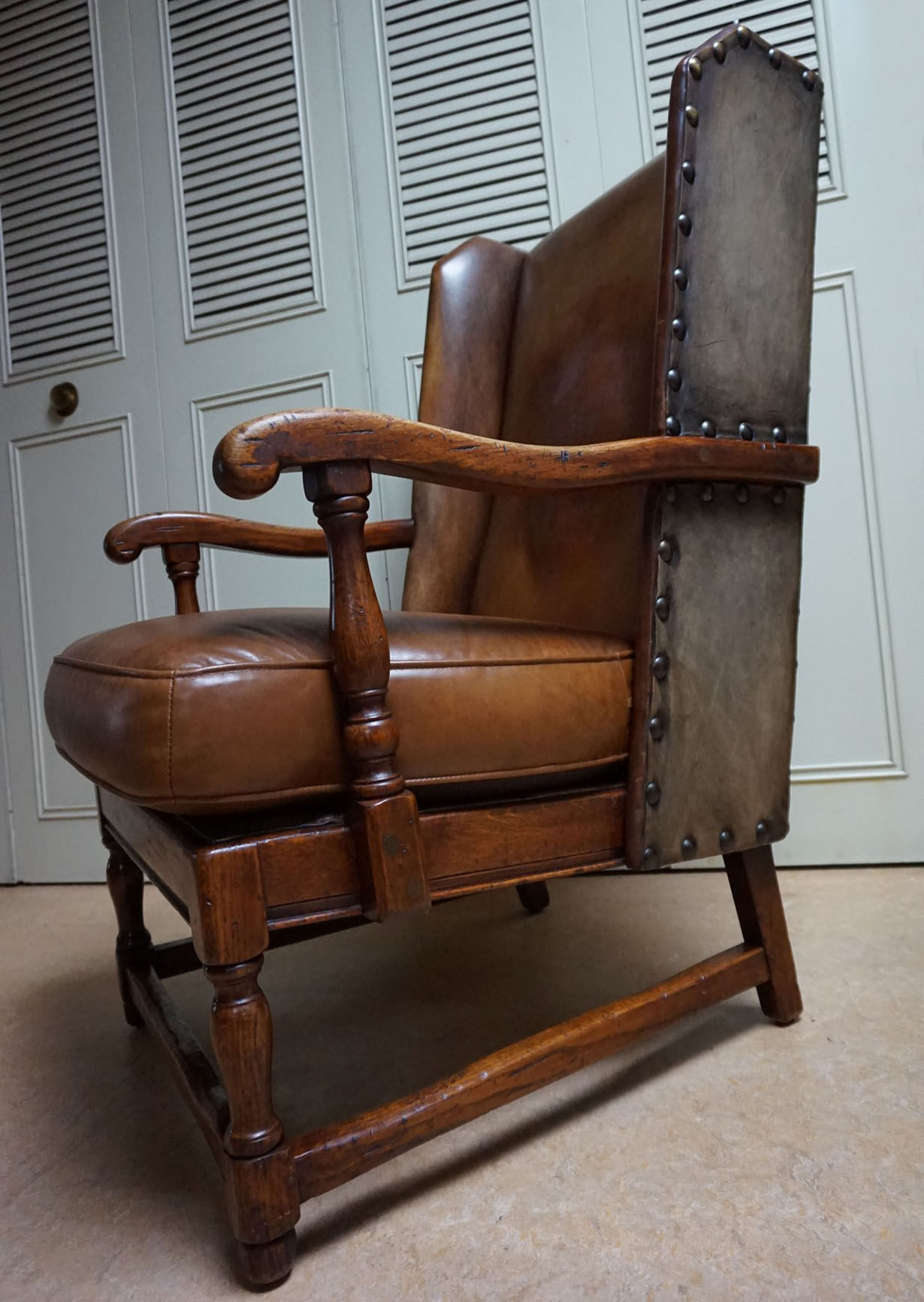 English high back cognac leather wingchair by Criterion cord
