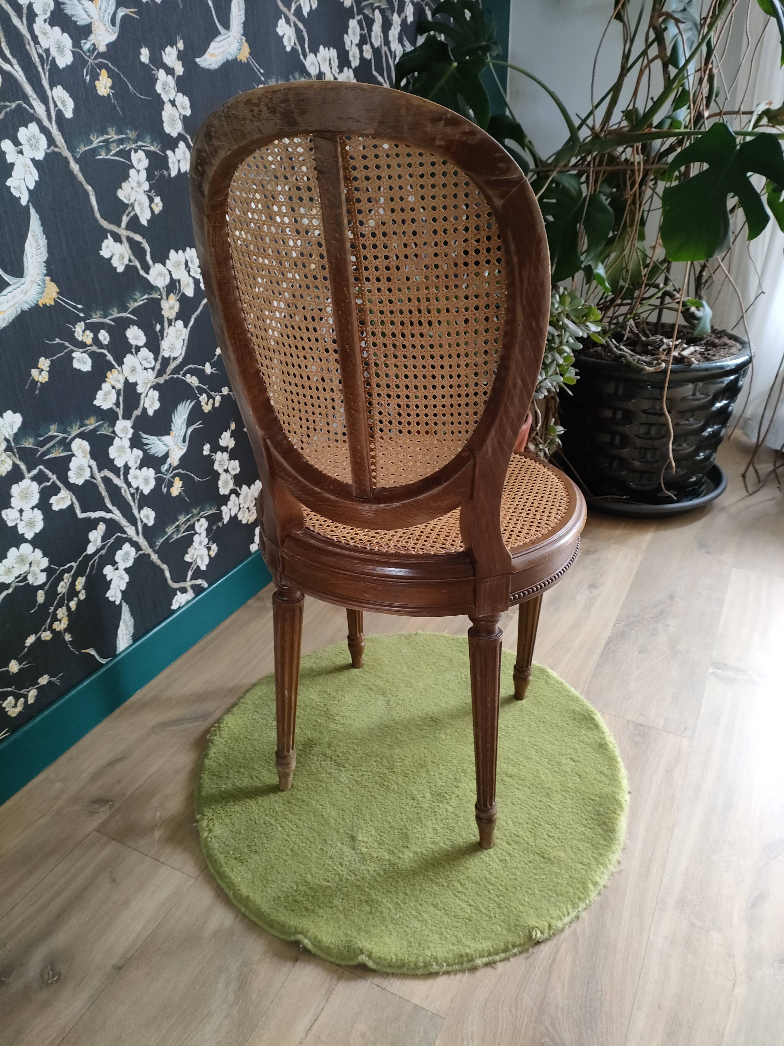 Wooden chair sitting in cannage