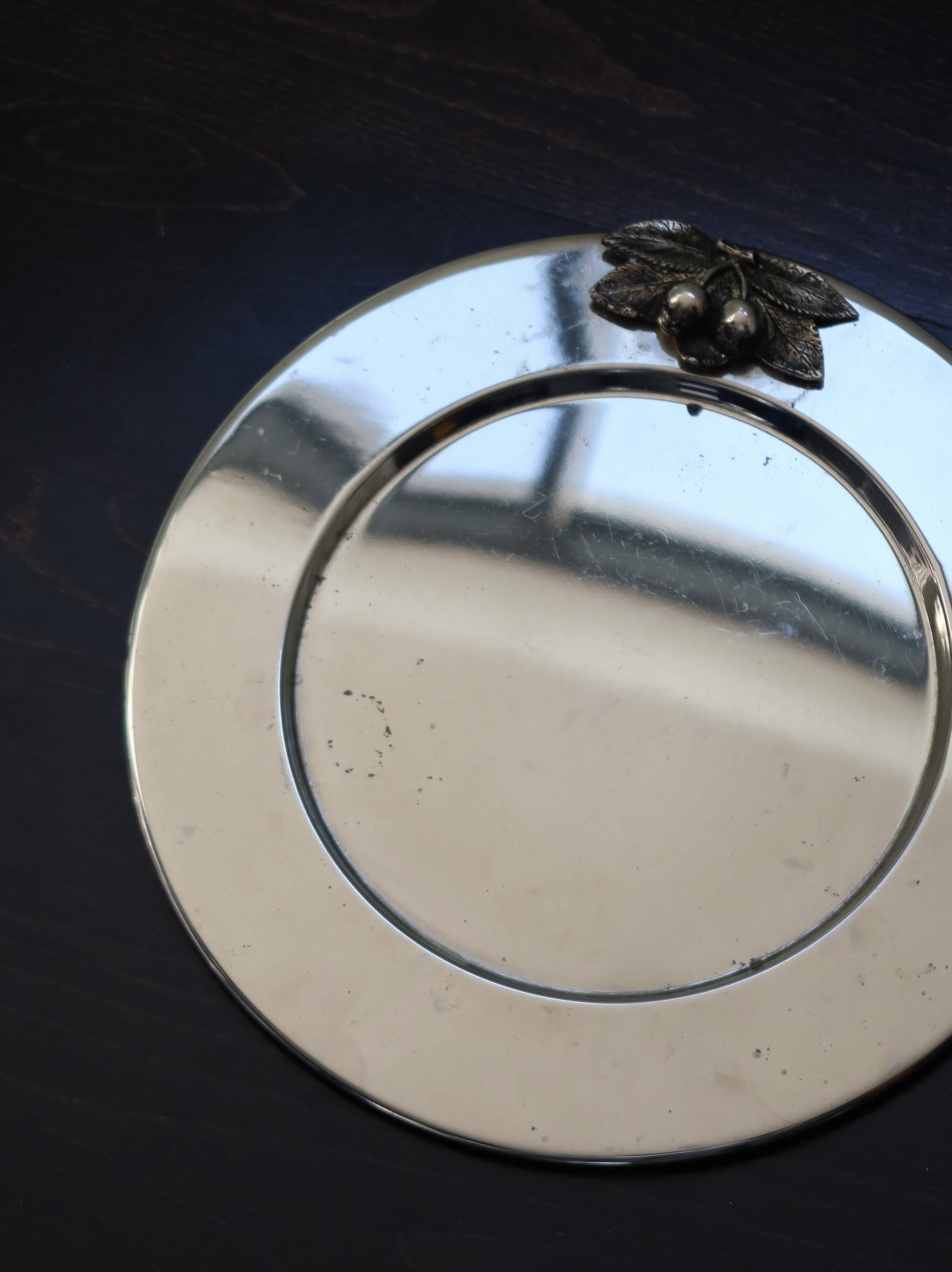 Vintage silver-plated round service tray with embossed cherries.