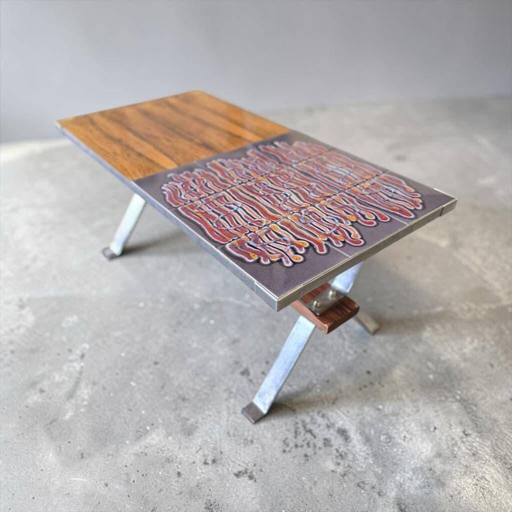 Vintage chrome coffee table with ceramic accent.