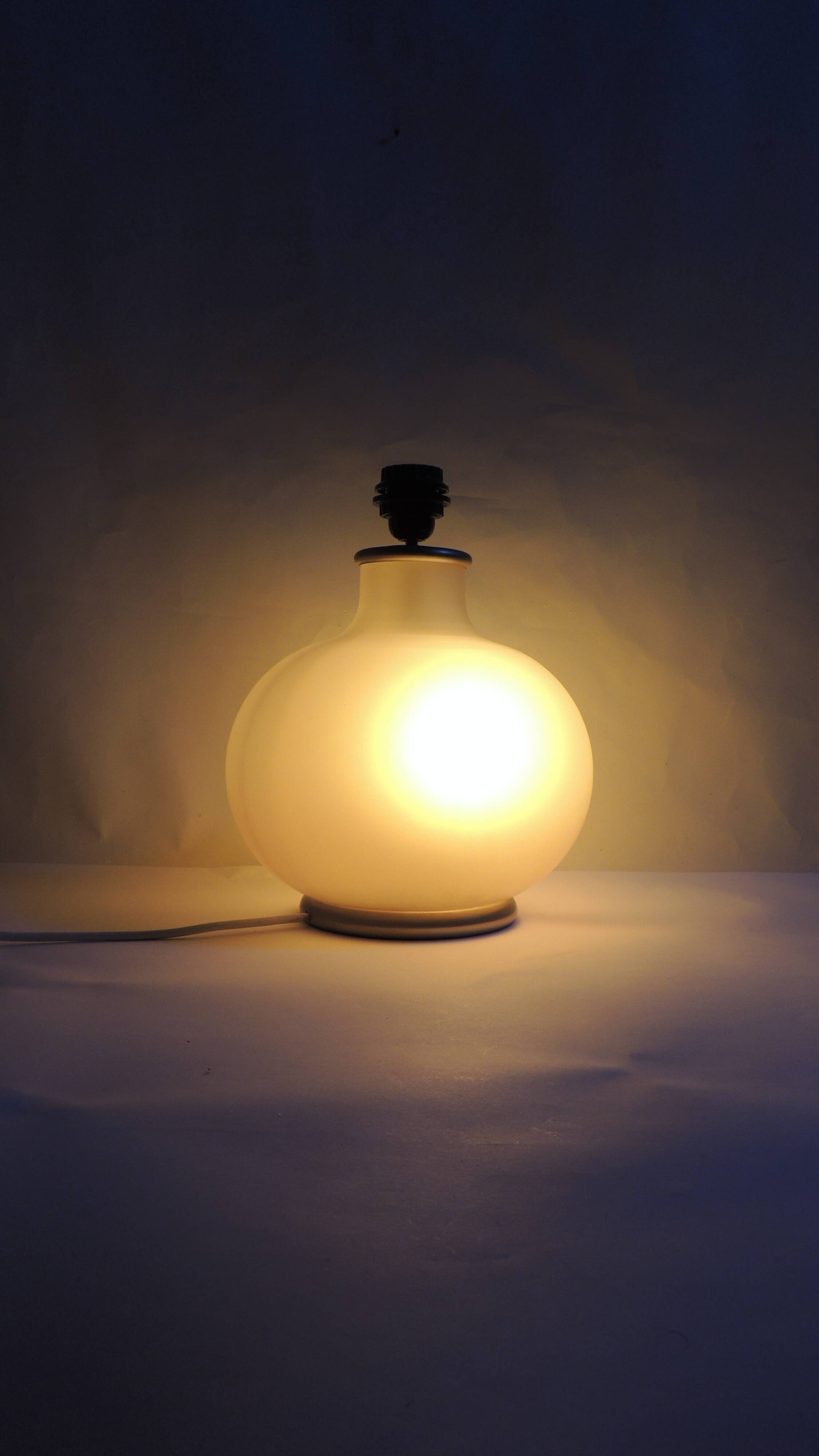 Vintage frosted glass lamp, round globe, elegant design, soft light.