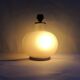 Vintage frosted glass lamp, round globe, elegant design, soft light.