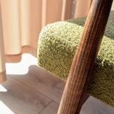 Mid-century modern armchair in olive green bouclé design by H. Lis.