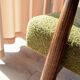 Mid-century modern armchair in olive green bouclé design by H. Lis.