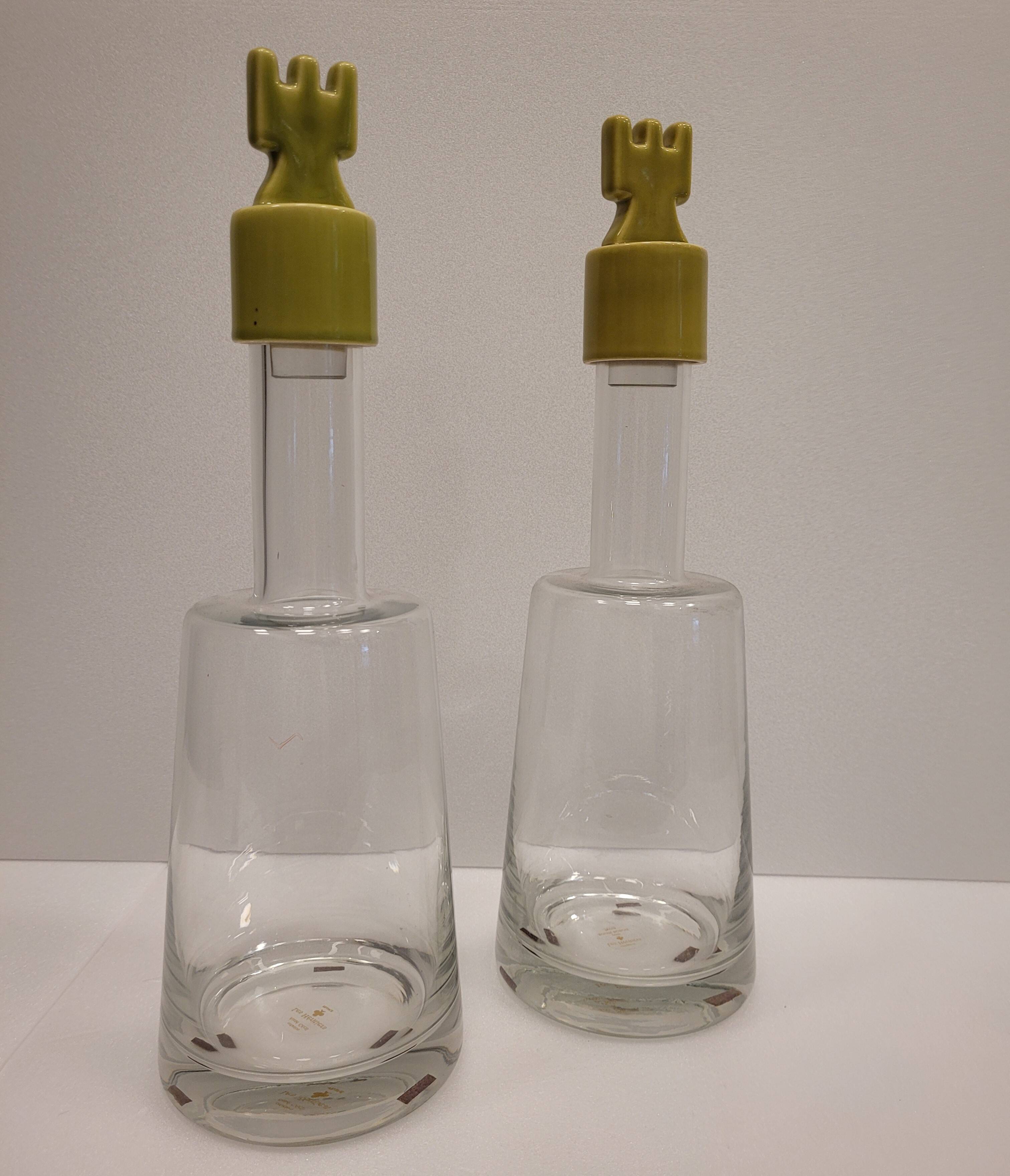 pair of decanters, bottles or jars, made in crystal with a ceramic tap enameled in green color