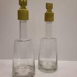pair of decanters, bottles or jars, made in crystal with a ceramic tap enameled in green color