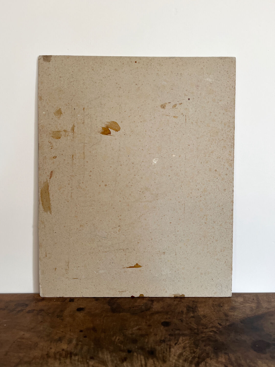 Old oil painting on cardboard portrait of a man in a dark suit