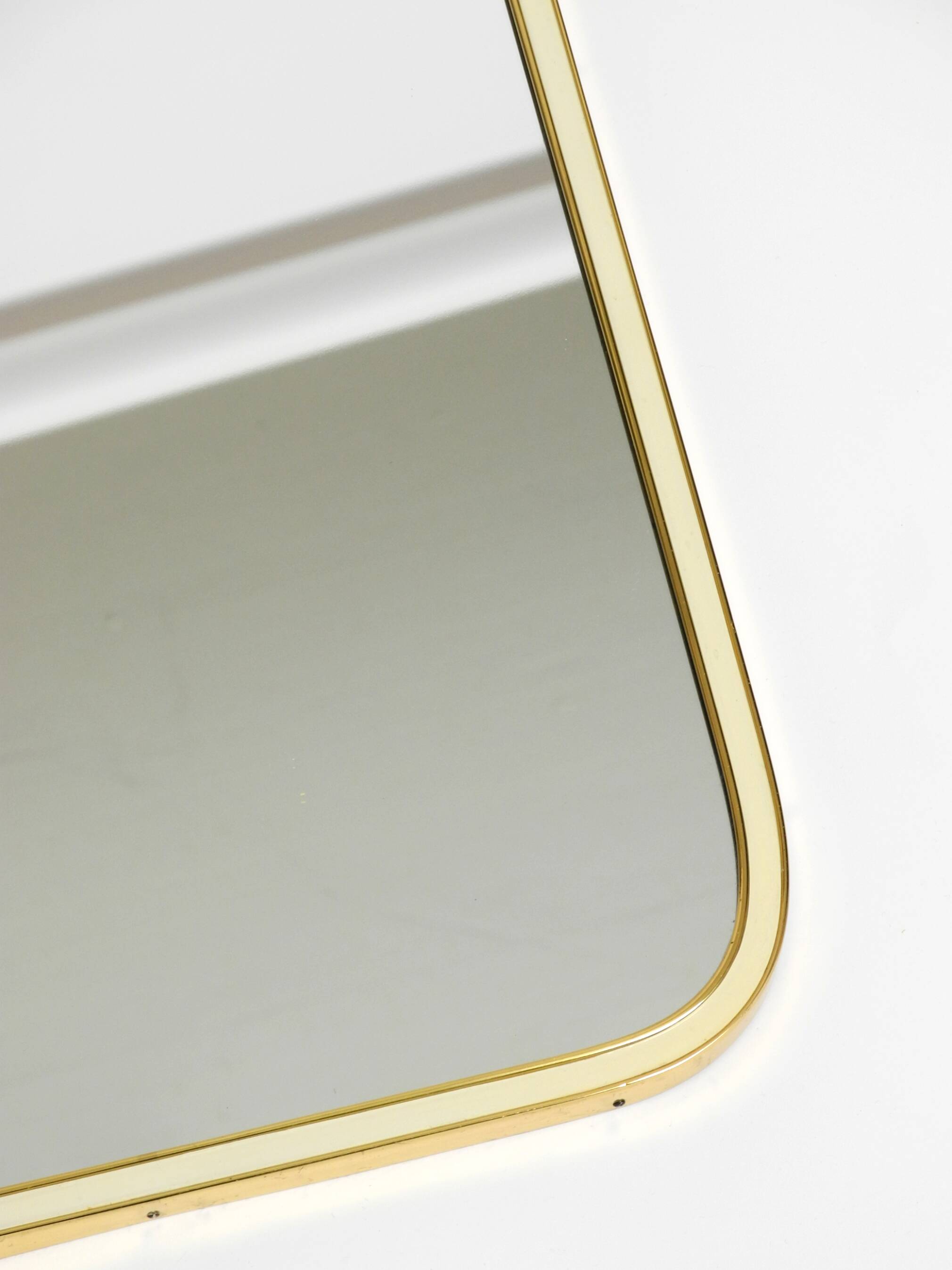 Large heavy long Mid Century brass wall mirror by Münchner Zierspiegel