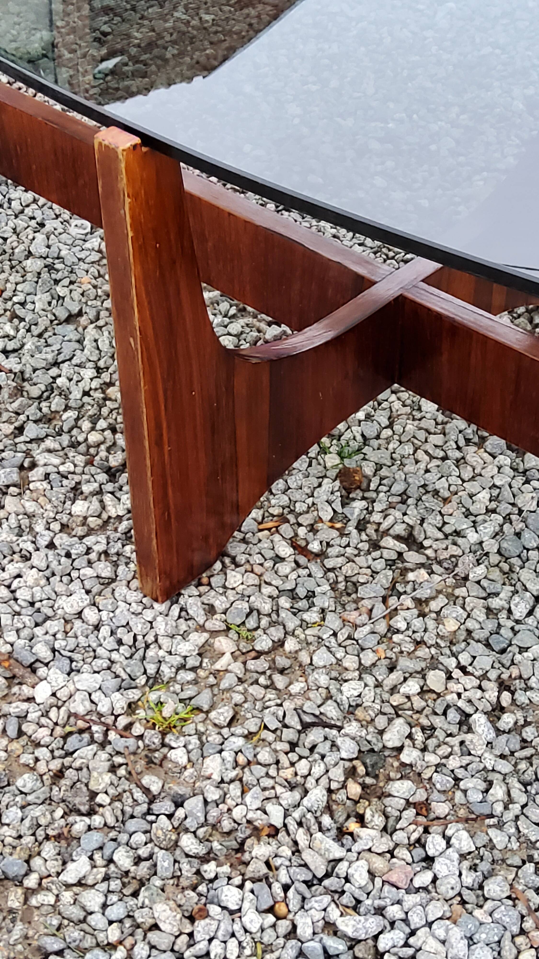 Designer coffee table by Hugues Poignant in rosewood and smoked glass from the 70s