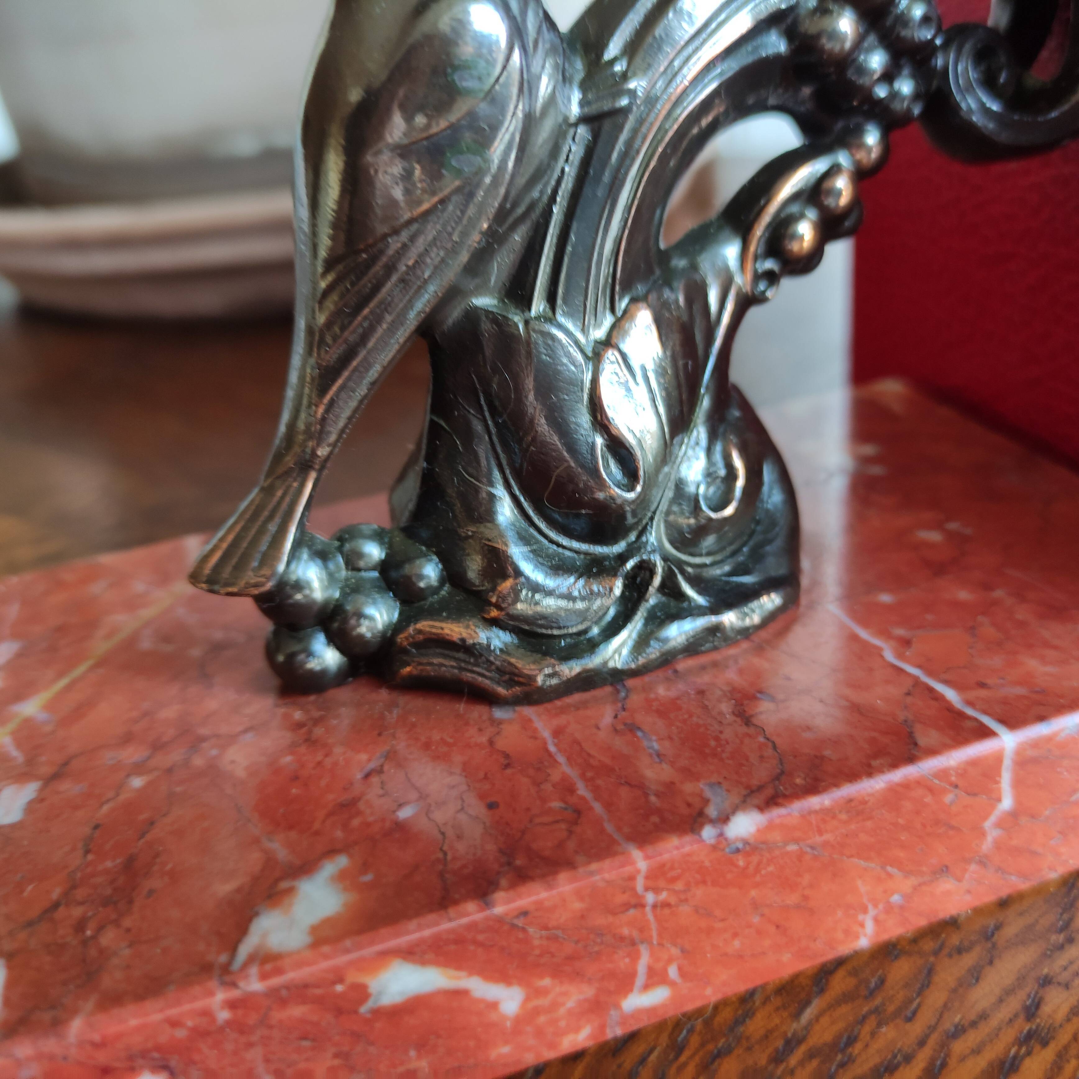 Zinc art bookends in the shape of birds on red marble - warblers